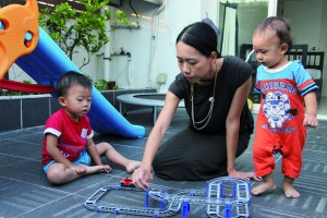 Katherine Lam Suet-ying plays with her sons.