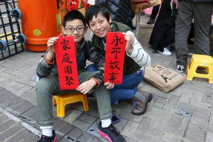 Abode seeker Ada Fu with her son at a sit-down protest.