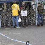 Students getting takeaway food through fences